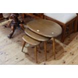 Nest of three vintage Ercol pebble tables (largest 40cm by 65cm by 45cm).