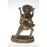 Tibetan erotic bronze figure of Yamantaka, naked male and female with headdress, 38cm.