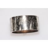 Silver hinged bangle with engraved decoration of birds, butterfly and water plants, 31mm wide.