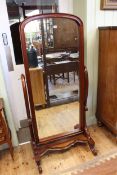 Mahogany dome top cheval mirror on scrolled supports, 168cm by 78cm.