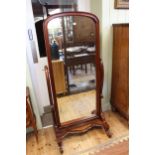 Mahogany dome top cheval mirror on scrolled supports, 168cm by 78cm.