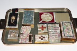 Collection of gilt metal and mother of pearl compacts.