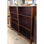 Late 19th/early 20th Century mahogany two division open bookcase on shaped bracket feet having six