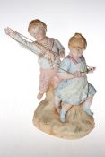 Heubach coloured bisque group of children playing, 30cm.