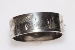 Silver hinged bangle with engraved decoration, 22mm wide.