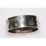 Silver hinged bangle with engraved decoration, 22mm wide.