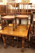 Oak draw leaf dining table and four chairs.