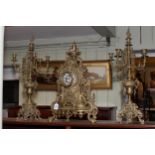 Large ornate gilt metal three piece clock garniture.