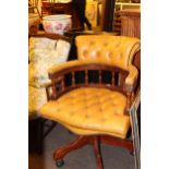 Captains style swivel desk chair in mustard buttoned leather.