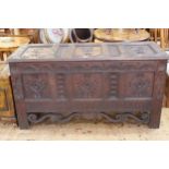 Good carved oak triple panel front kist dated 1867 to interior of lid, 81cm by 155cm by 60cm.
