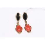 Coral and onyx pendant earrings set in 18 carat gold.