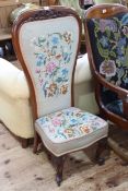 Victorian mahogany prie dieu chair with carved foliate crest and needlework fabric.