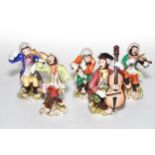 Continental porcelain five piece monkey band, four Dresden, average 16cm high.