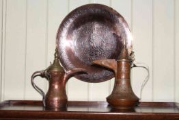 Islamic silver inlay circular copper dish and pair of copper and brass ewers.