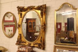 Ornate gilt framed oval bevelled wall mirror, rectangular and oval gilt framed wall mirrors (3).