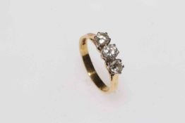 Three stone diamond 18 carat gold ring, size L.