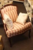 Occasional open armchair in striped fabric.