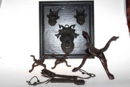 Framed set of three Nigerian heads, three wooden stands and leather knife sheaths.