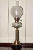 Brass reeded column oil lamp with clear glass reservoir and frosted and etched glass shade.