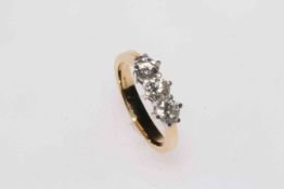 Three stone diamond 18 carat gold ring, total in excess of 1 carat, size N.