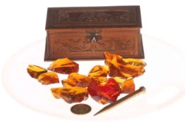 Small carved wood box with elephant and pieces of amber.