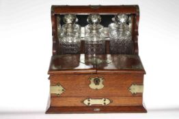 Early 20th Century oak and EP mounted combination three bottle tantalus gaming box, 36cm high.