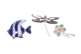 Three Swarovski brooches, blue fish, dragonfly and flowers.