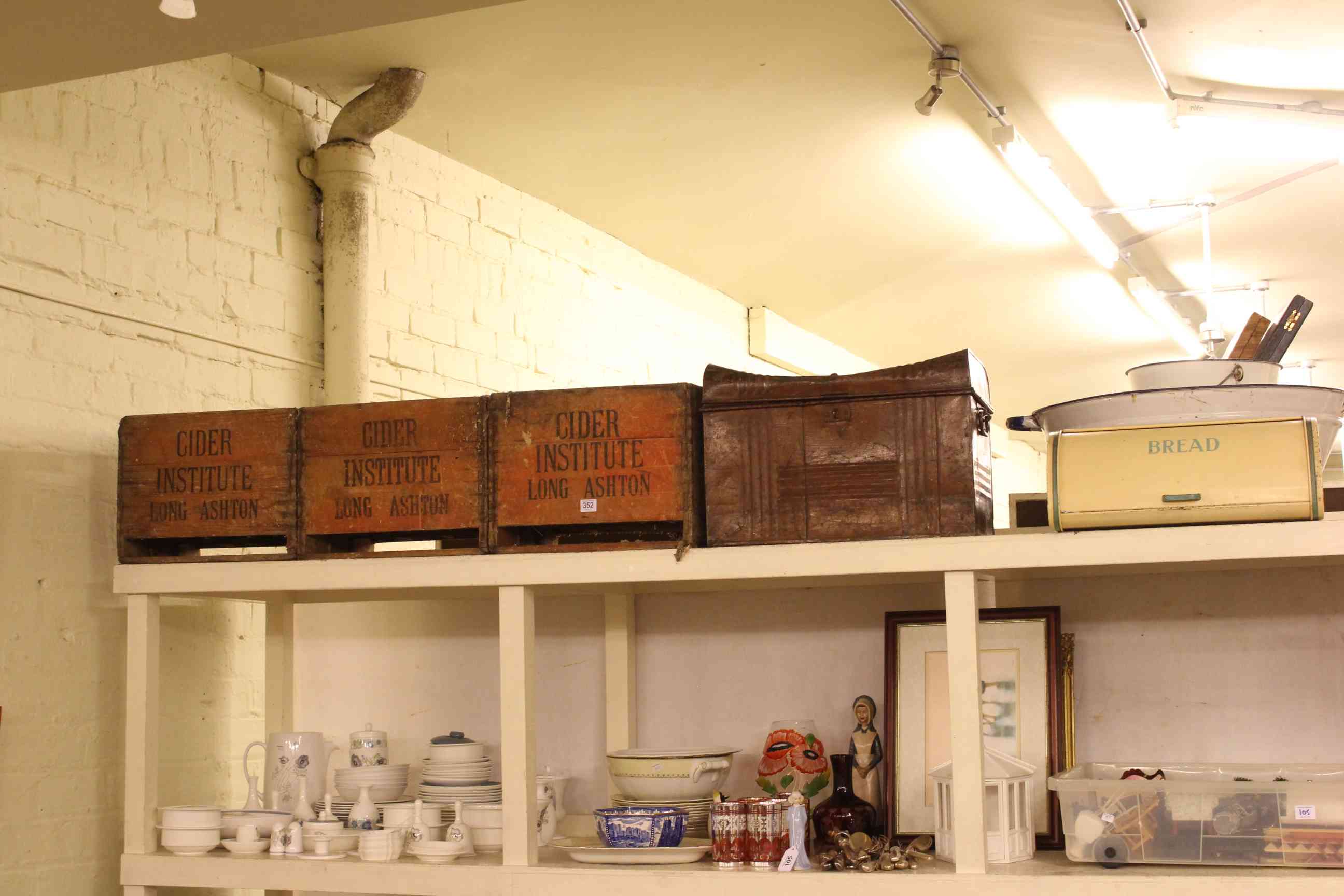 Three vintage cider crates, tin trunk and enamel wares.