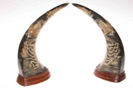 Pair carved horns decorated with dragons and serpents, 32cm.