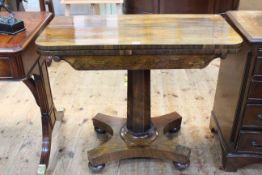 Victorian rosewood fold top card table on octagonal pedestal to quadriform base, 76.5cm by 91.