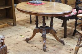 Victorian walnut and satinwood inlaid oval breakfast table raised on four turned supports to four