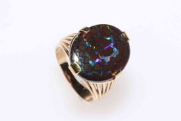 14k gold large opal ring, the oval stone set above pierced shoulders, size O.