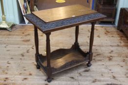 Carved oak centre table with undershelf, 80cm by 84cm by 53cm.