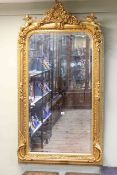 Good gilt framed rectangular bevelled wall mirror with foliate crest flanked by cherubs,
