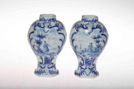 Pair Delft blue and white vases, each with panel of figure in river scene, 18.5cm.