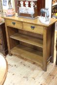 Oak Arts & Crafts style two drawer open bookcase, 92.5cm by 102cm by 36cm.