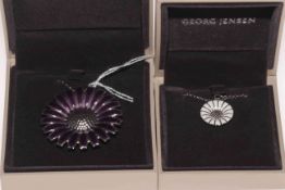 Two Georg Jensen silver pendants, flower with purple leaves and daisy, both with boxes.