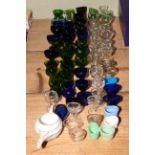 Quantity of various eye baths in green, Bristol blue and clear glass.