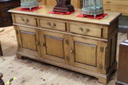 Jointed oak dresser having three drawers above three fielded panel doors, 79.5cm by 152cm by 44cm.
