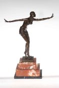 Bronze figure of a female dancer on a marble plinth, 48cm high.