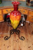 Large, probably Linthorpe pottery vase in wrought iron stand, overall height 89cm.