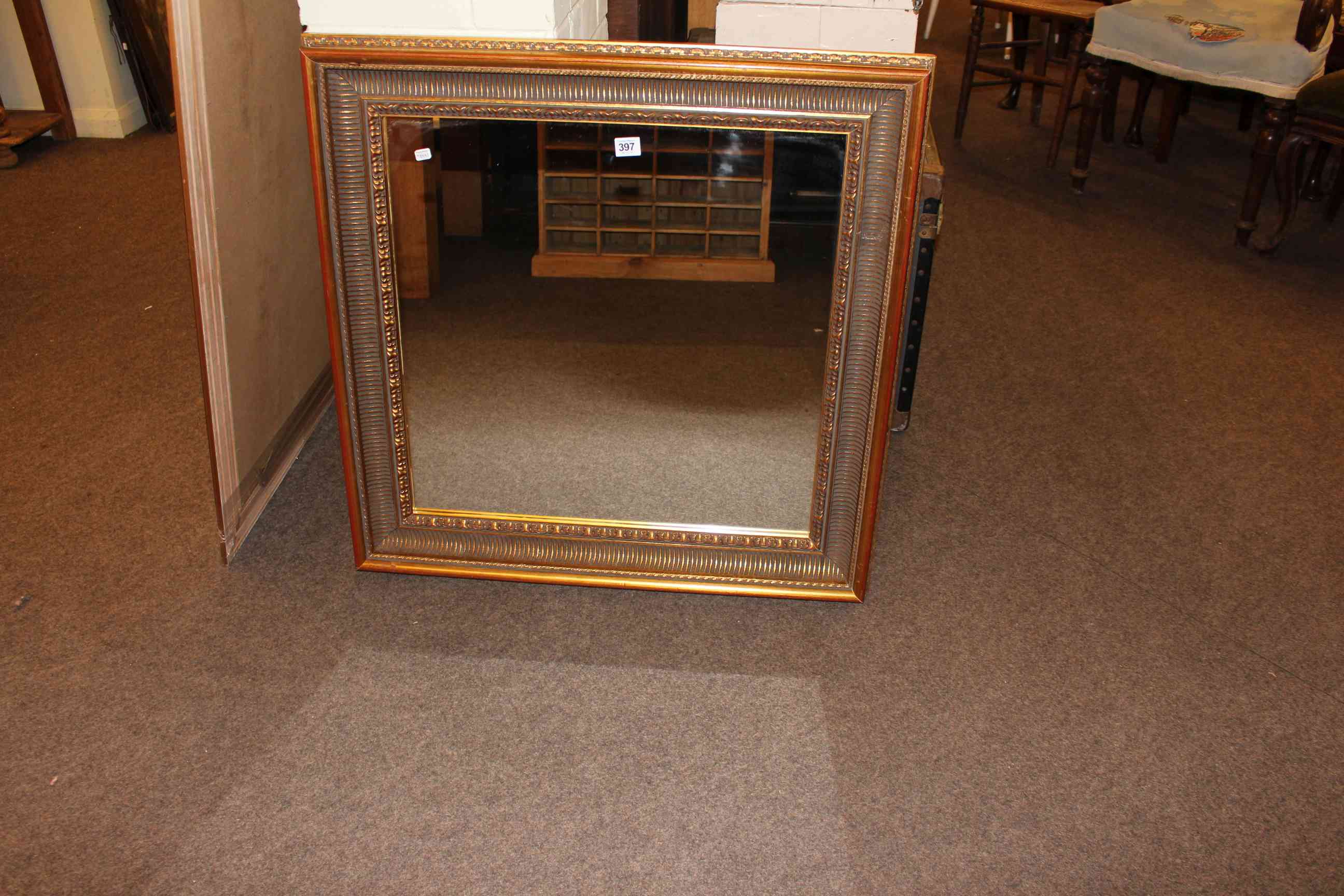 Gilt reeded framed wall mirror, 78cm by 78cm.