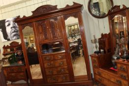 Good late Victorian carved walnut three piece bedroom suite comprising triple combination wardrobe,