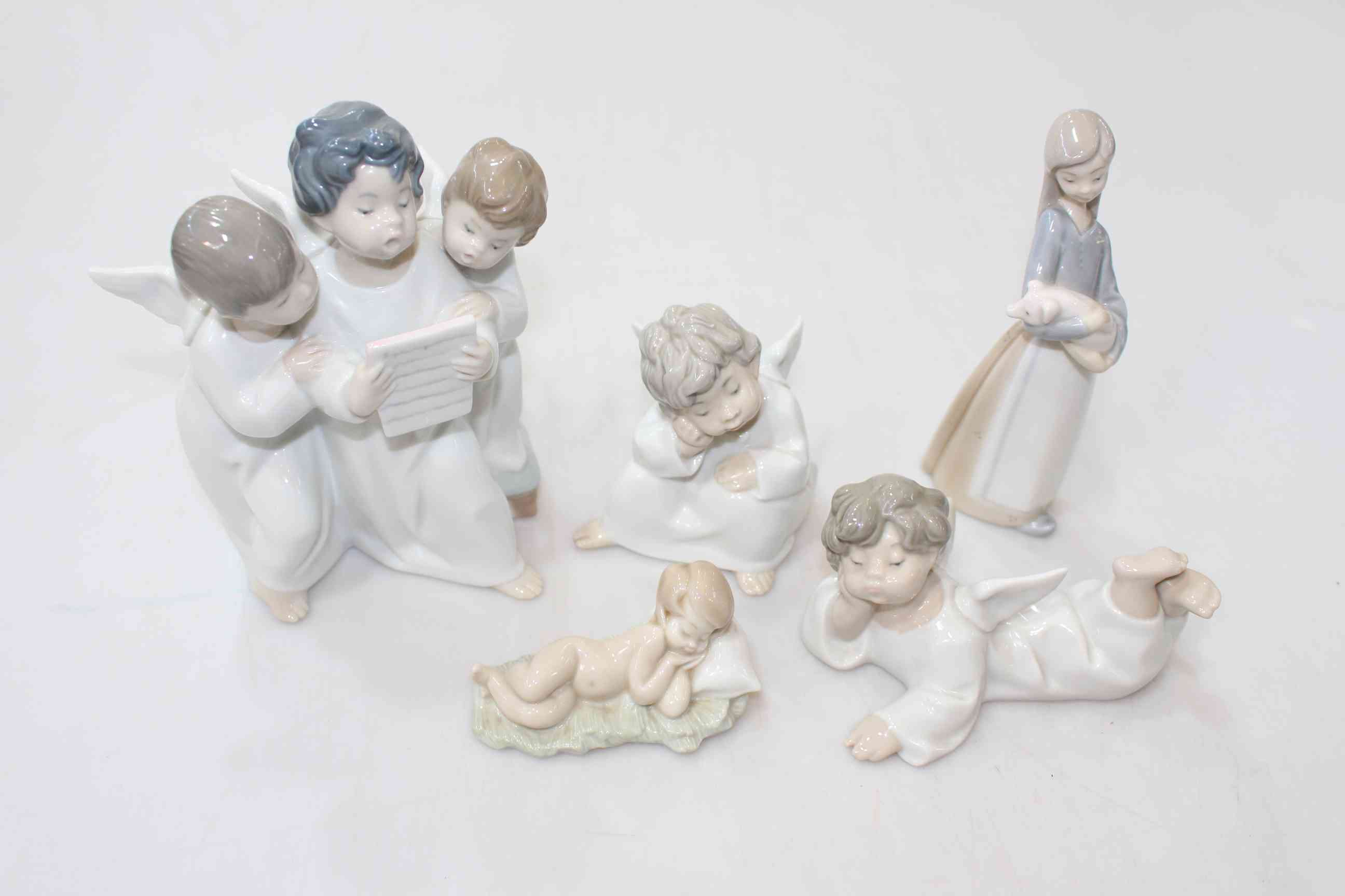 Four Lladro Cherub figurines and Girl with Piglet (5).