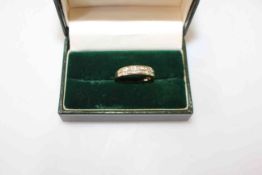 Diamond set 18k gold half eternity ring having two rows of emerald cut stones, size Q.