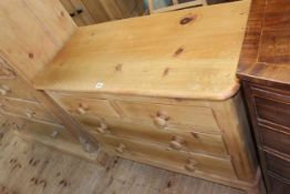 Stripped pine chest of two short above two long drawers on turned legs, 80cm by 106cm by 48cm.