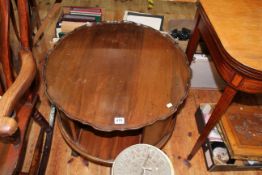 Mahogany circular shaped revolving book table on ball and claw legs, 56cm by 60cm diameter.
