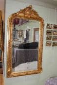 Good gilt framed rectangular bevelled wall mirror with foliate crest, 153cm by 84cm.