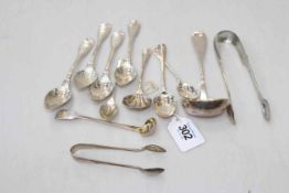 Various silver spoons and tongs.
