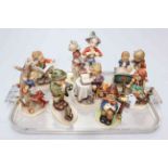 Collection of eight Hummel children figures and groups.